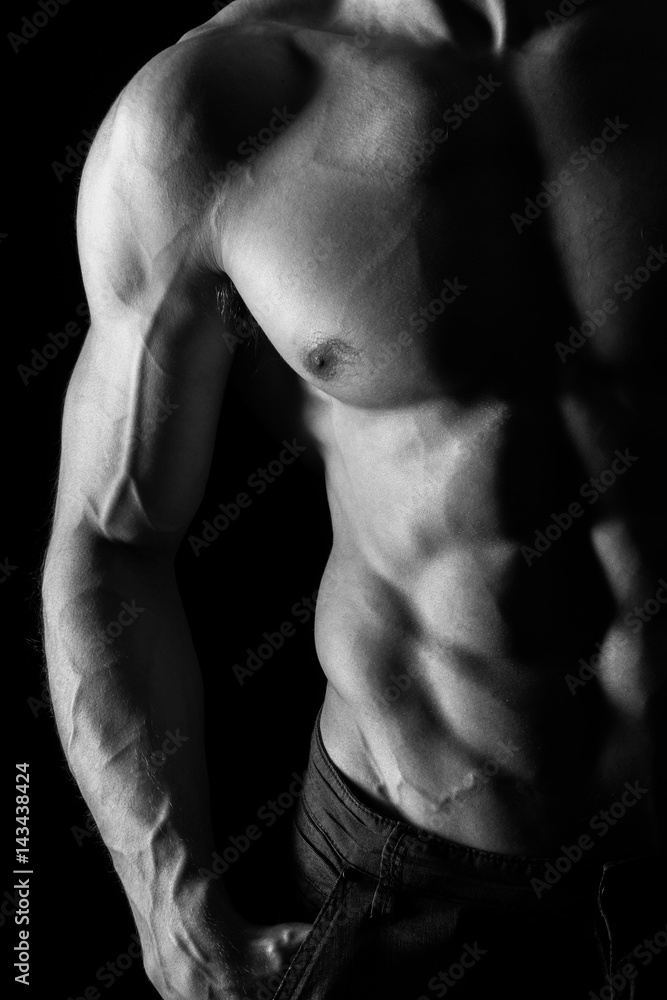 Muscular Torso of Sexy Shirtless Young Male Model Close Up on Black Background Muscular Torso of Sexy Shirtless Young Male Model Close Up on Black Background