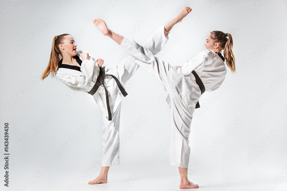 The studio shot of group of kids training karate martial arts The studio shot of group of kids training karate martial arts
