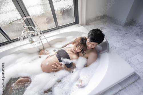 Pregnant woman with her husband spend much time together