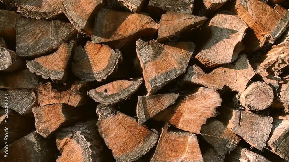 Pile of stacked oak firewood slide movement in slow motion. Pile of stacked oak firewood slide movement in slow motion.