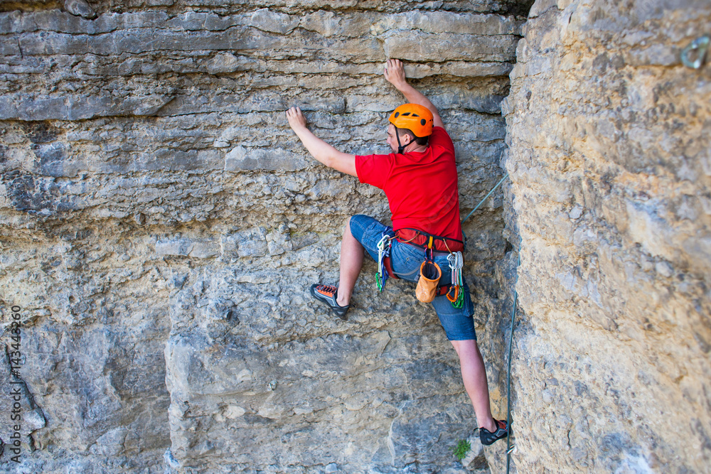 Climber in a helmet climbs up. Climber in a helmet climbs up.
