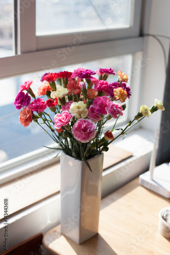 Indoor flower on the windowsill. white vase, pot. curtains tulle