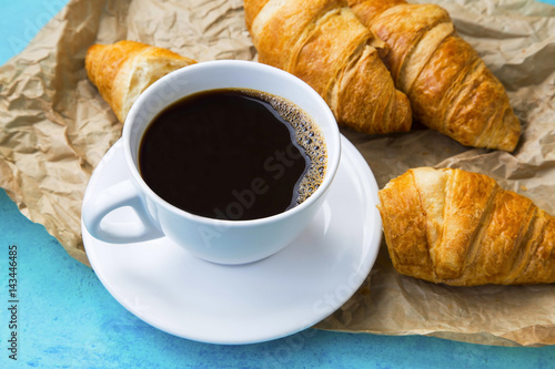 Fresh coffee cup with croissants.Breakfast meal concept