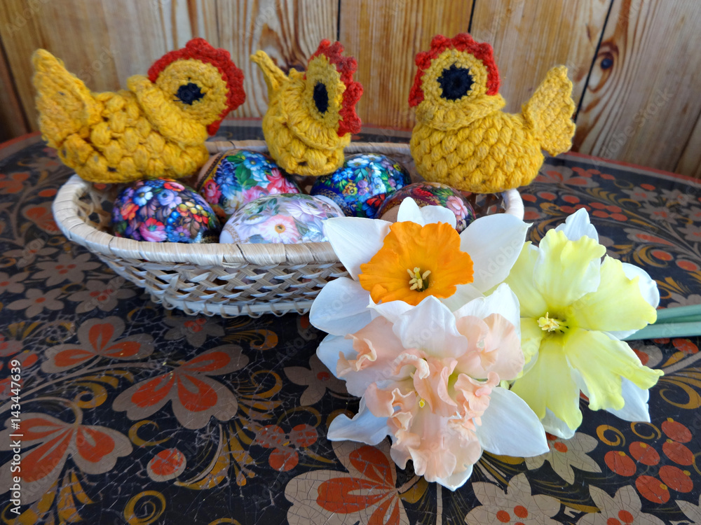 Easter eggs, Chicks, spring flowers daffodils painted on a wooden background