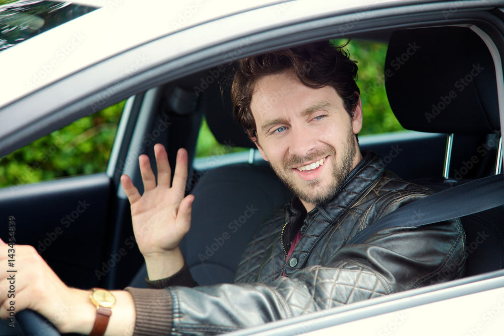 Cool man driving car saying hello Cool man driving car saying hello