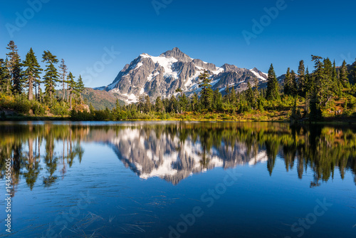 Mt Shuksan in North Cascades National Park reflects in Picture Lake which is on the slopes of the adjacent Mount Baker