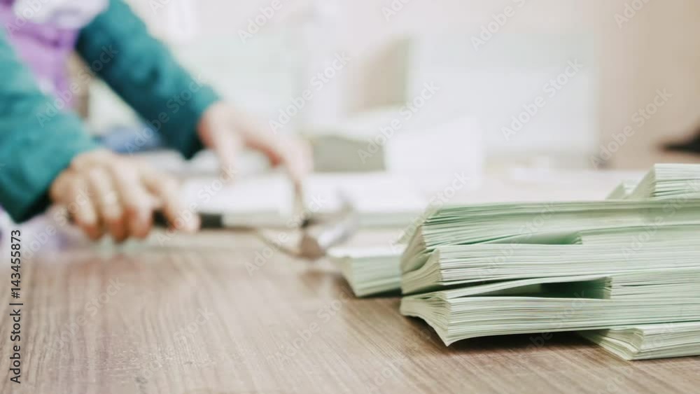 Woman in typography - complements the pages of the brochure with a hammer at polygraph industry, manual labour Woman in typography - complements the pages of the brochure with a hammer at polygraph industry, manual labour