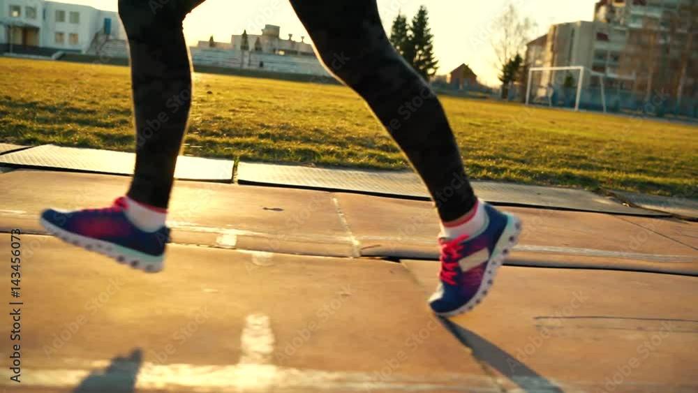 Legs of a woman running through the stadium Legs of a woman running through the stadium
