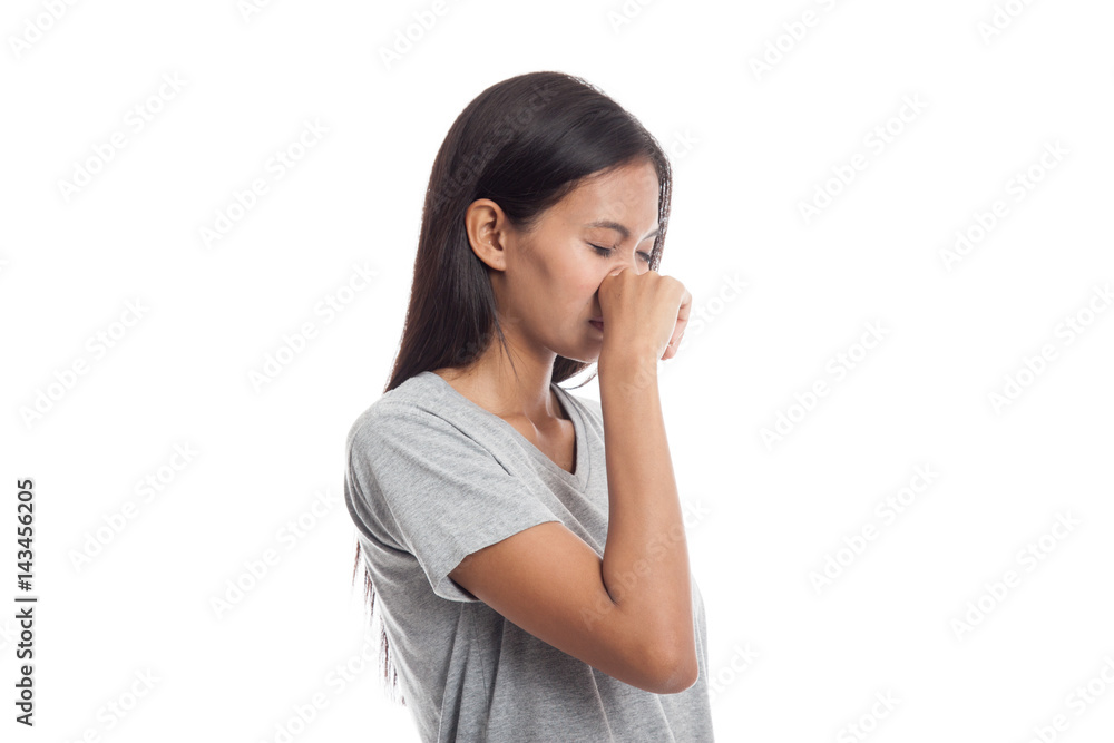 Young Asian woman holding her nose because of a bad smell. Young Asian woman holding her nose because of a bad smell.