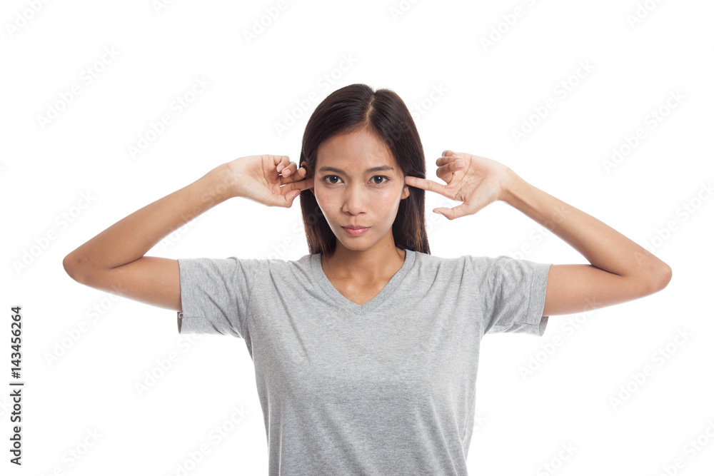 Young Asian woman block both ears with fingers. Young Asian woman block both ears with fingers.