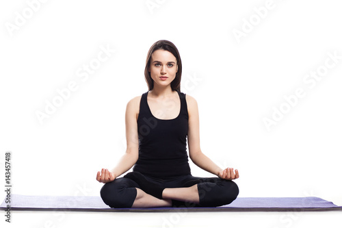 Girl is engaged in yoga on a white background, concept of health