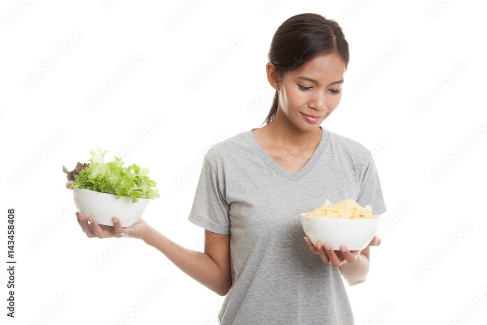 Young Asian woman with potato chips and salad. Young Asian woman with potato chips and salad.