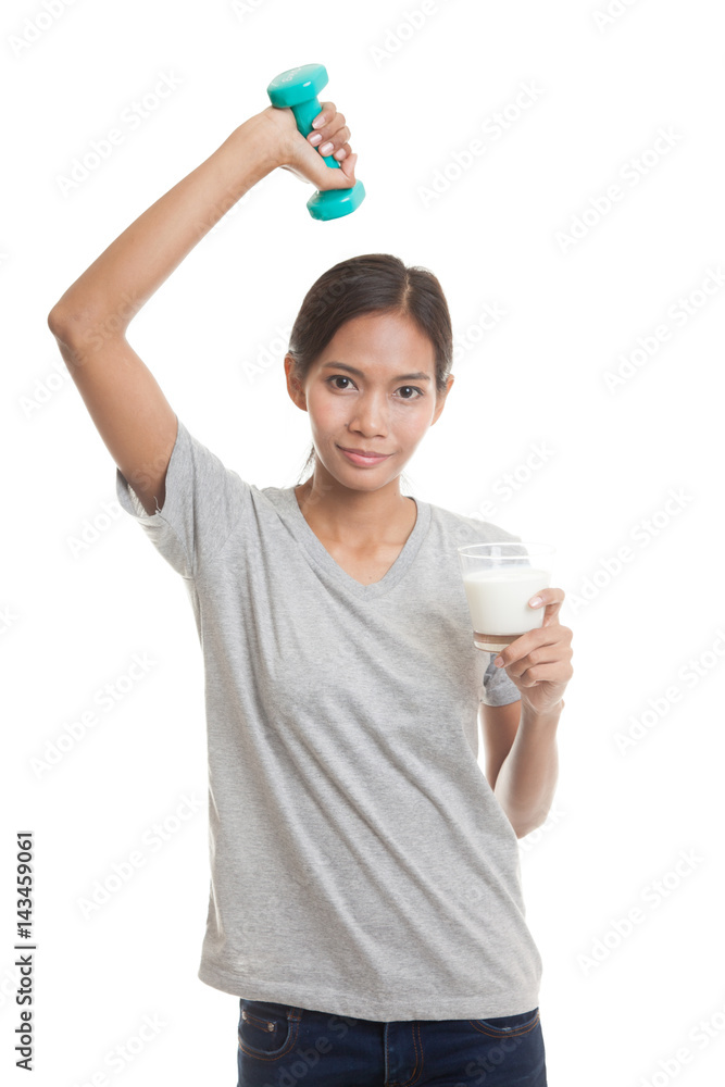 Healthy Asian woman drinking a glass of milk and dumbbell. Healthy Asian woman drinking a glass of milk and dumbbell.