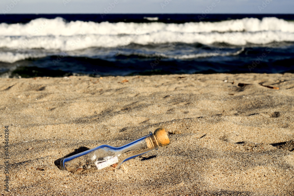 a bottle with a letter on sandy coast a bottle with a letter on sandy coast