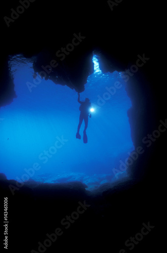 Diver at the enterance of a marine cave, Sarigerme Turkey