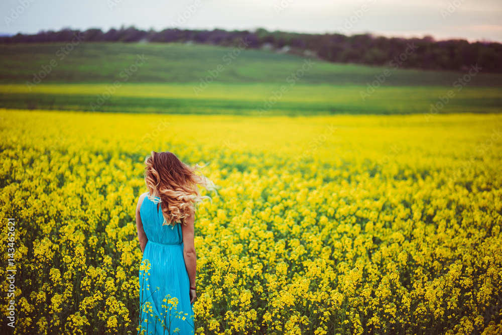 The charming girl stands near many flowers The charming girl stands near many flowers