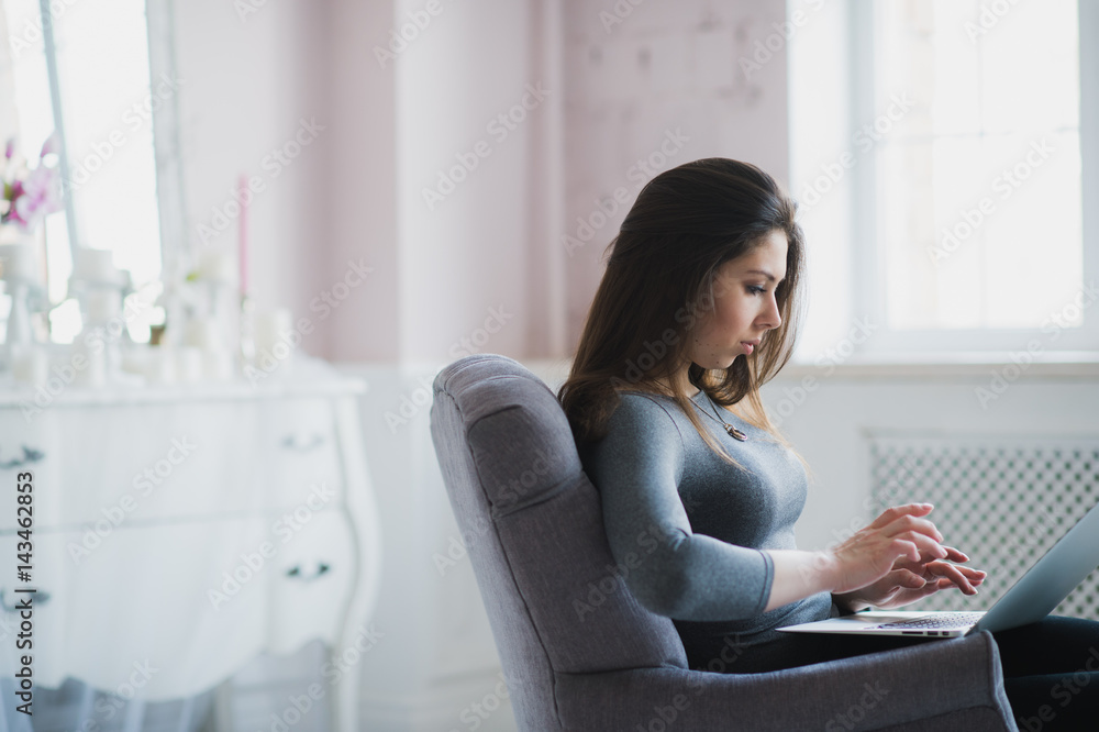 Young attractive woman at home, working with laptop, free online classes for interest, stay-at-home mom starting an online business, internet marketing, remote job, lady- blogger Young attractive woman at home, working with laptop, free online classes for interest, stay-at-home mom starting an online business, internet marketing, remote job, lady- blogger