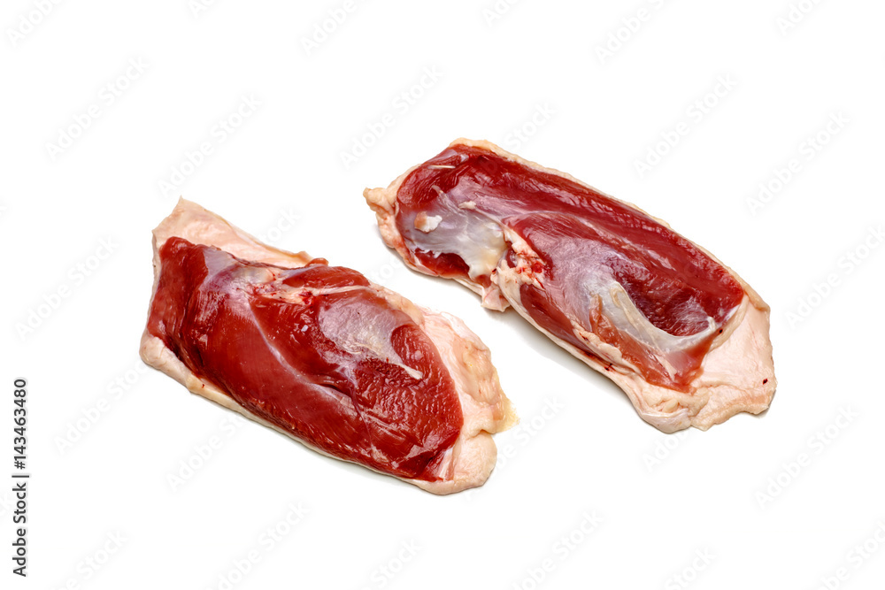 Raw duck breast lying on a white background, not isolated, with a shadow. Raw duck breast lying on a white background, not isolated, with a shadow.