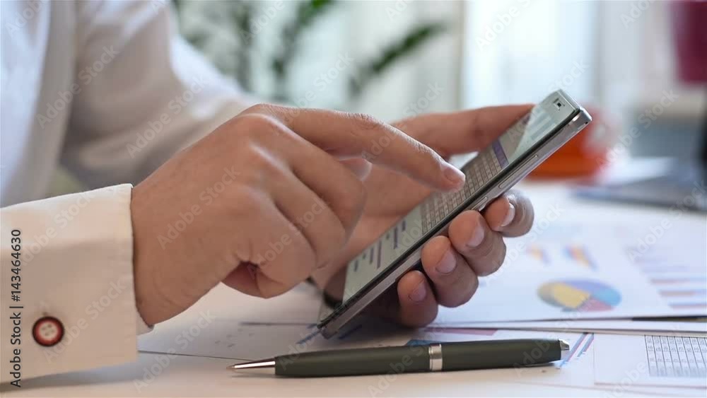Trader Monitoring Income Charts And Business Reports On Smartphone Screen. Business Concept Trader Monitoring Income Charts And Business Reports On Smartphone Screen. Business Concept