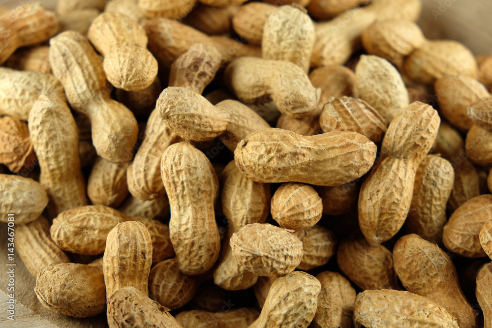 Peanuts in a wooden bowl - close-up. Peanuts in a wooden bowl - close-up.