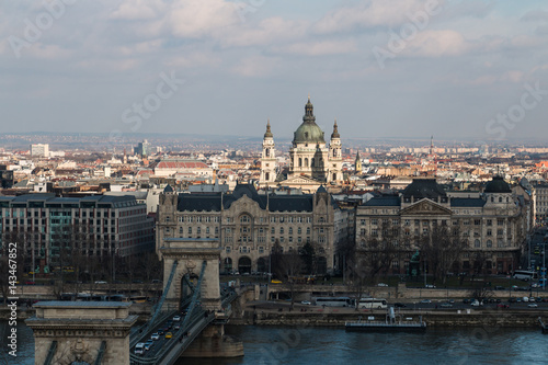 Scenic view of Pest side with St. Stephen's Basilica in center and Danube river with Chain Bridge in Budapest Hungary on a sunny day
