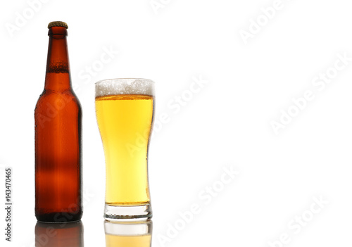 Bottle and a glass of beer with foam isolated on white background