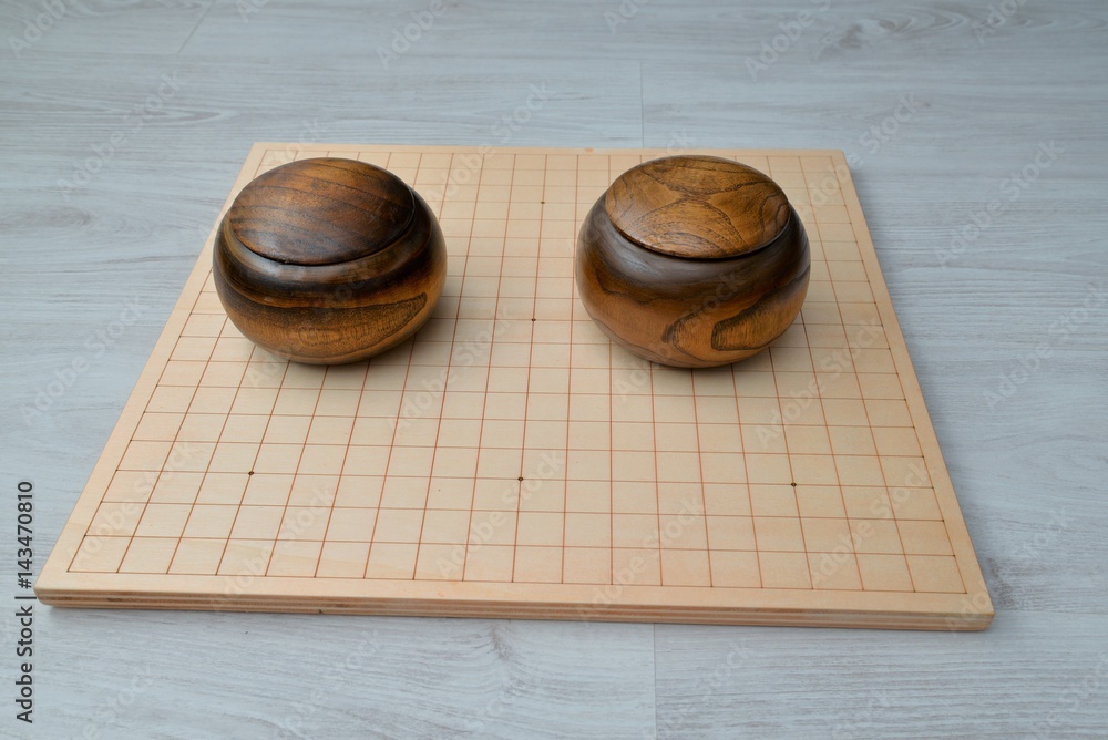 Go game set. Go is an abstract strategy board game for two players, in  which the aim is to surround more territory than the opponent Stock Photo |  Adobe Stock