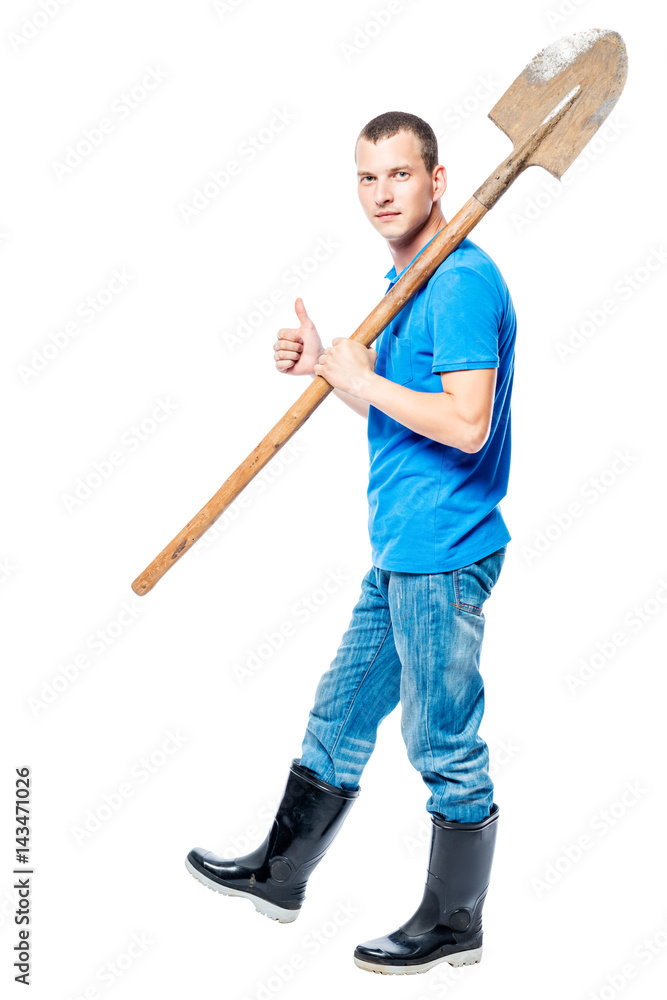 Working man with a shovel goes to dig on a white background Working man with a shovel goes to dig on a white background
