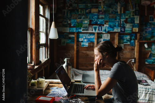 Young woman using laptop while sitting indoors