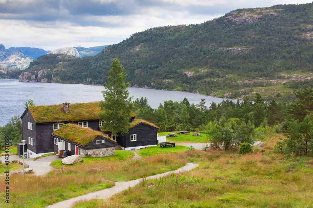 Beautiful landscape of Norway homes with green roofs and, mountainous terrain and reservoirs Beautiful landscape of Norway homes with green roofs and, mountainous terrain and reservoirs