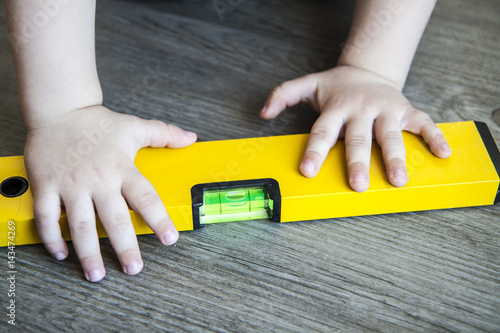 spirit level in young boy hand - child with waterlevel