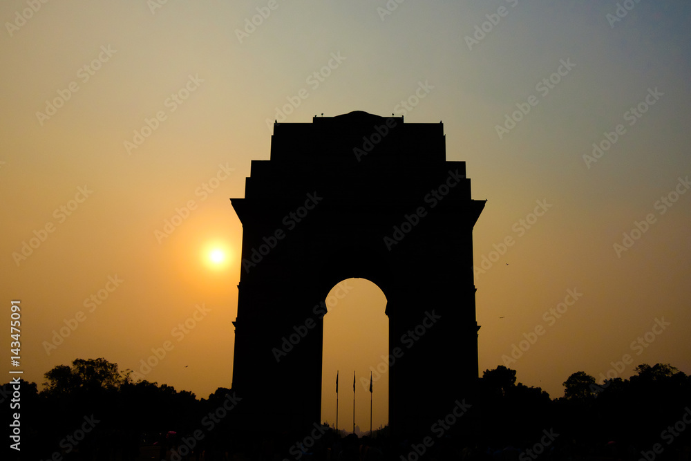 silholuette of gate of india arch in new delhi india at sunset with tourists crowd