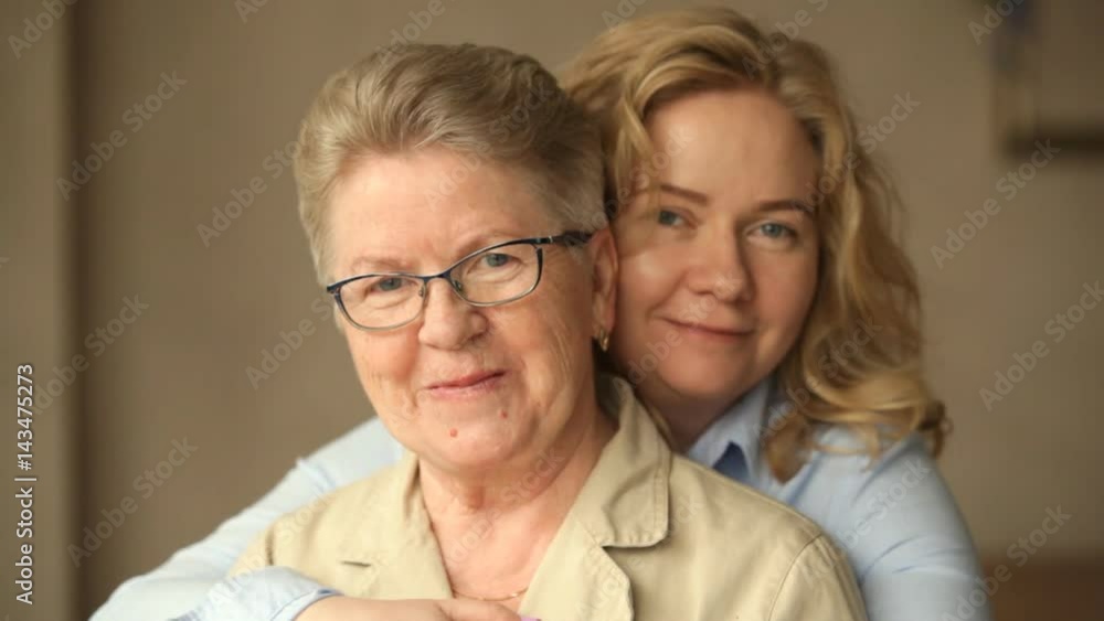 adult daughter hugging mother adult daughter hugging mother