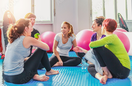Group of women hanging out after pilates exercise.