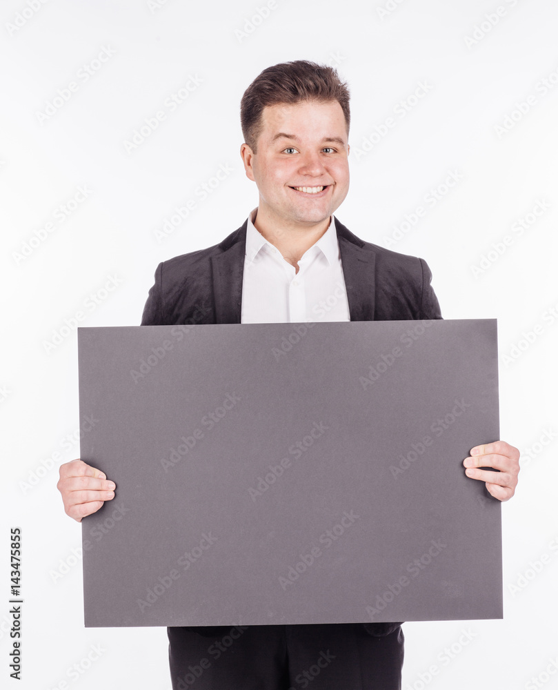 young man holding black blank panel with space for text on white background. young man holding black blank panel with space for text on white background.