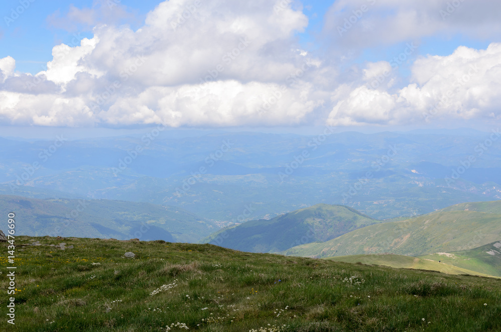 Green mountains and white puffy clouds Green mountains and white puffy clouds