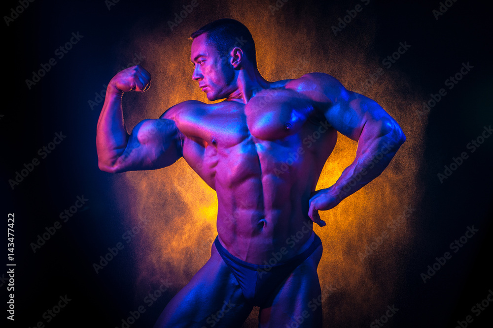 An athlete with big muscles. Athletic person. Bodybuilder. Body-building.