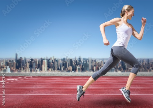 Female runner going on track against skyline