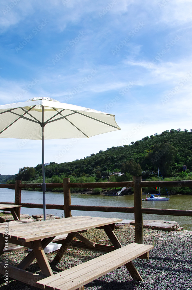 wooden chairs and table near guadiana river,Portugal wooden chairs and table near guadiana river,Portugal