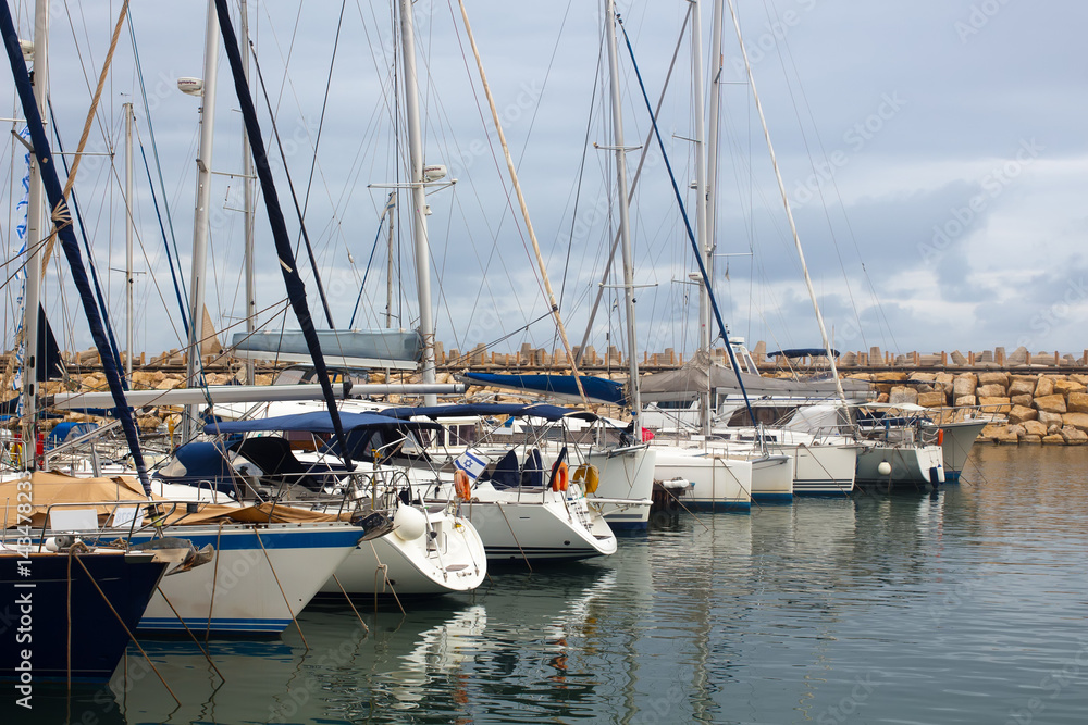 Yachts and boats in marina on a cloudy day