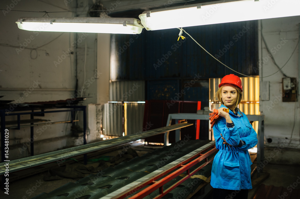 beautiful woman in red safety helmet work as industrial worker