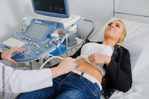 Doctor makes the patient women abdominal ultrasound.