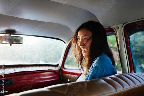 Happy woman laughing while sitting in the car