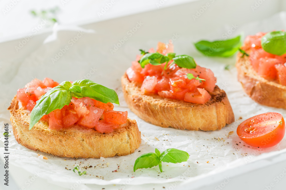Tasty bruschetta with basil and tomato for a snack Tasty bruschetta with basil and tomato for a snack
