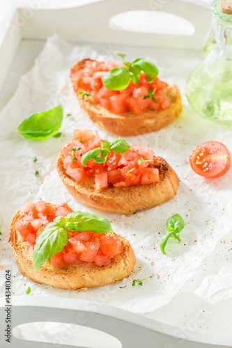 Delicious bruschetta with tomato and basil for breakfast