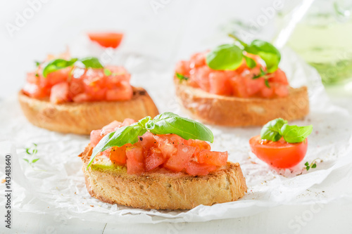 Tasty bruschetta with tomato and basil for breakfast