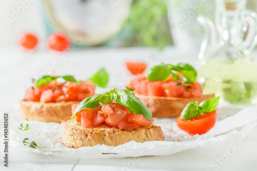 Delicious bruschetta with basil and tomato for breakfast