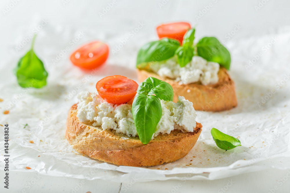 Tasty bruschetta with ricotta cheese and tomato for a snack Tasty bruschetta with ricotta cheese and tomato for a snack