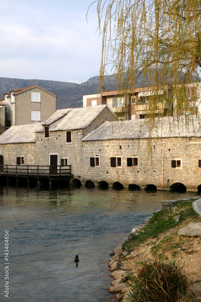 Traditional 17th-century watermill called 'Gaspina mlinica' on river Jadro in Solin, Croatia. Selective focus. 