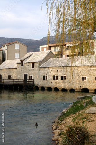 Traditional 17th-century watermill called 'Gaspina mlinica' on river Jadro in Solin, Croatia. Selective focus.  photo